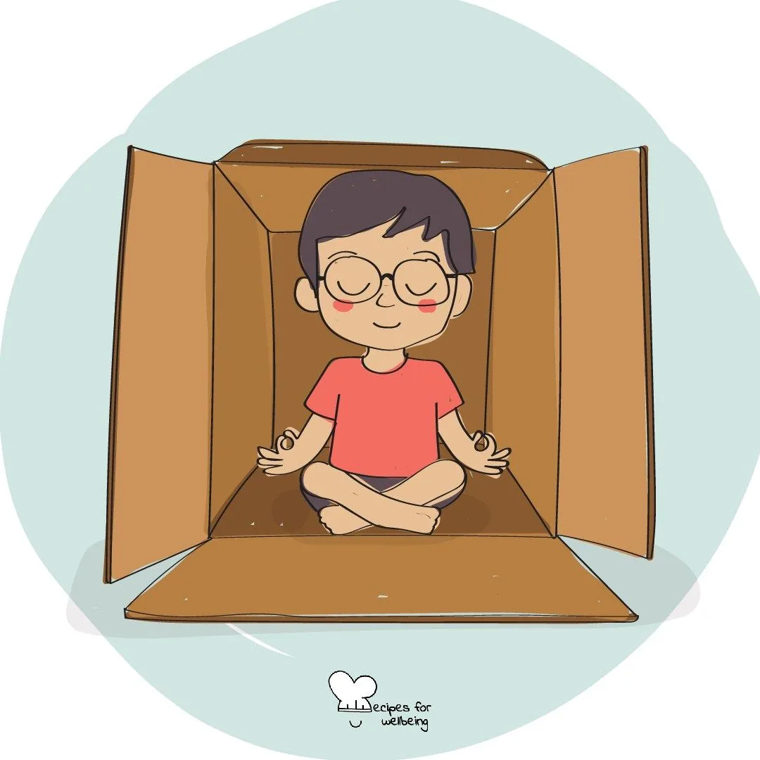 A child sitting cross-legged inside an open cardboard box