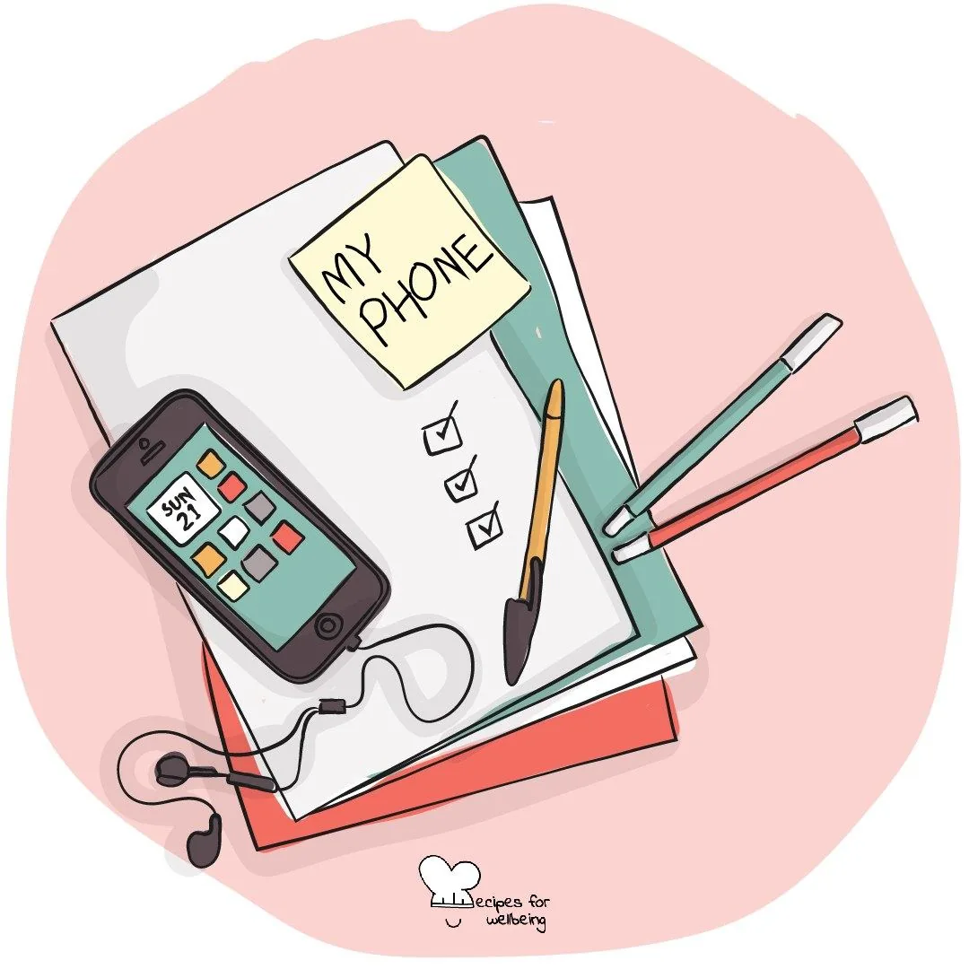 A phone lying beside a notebook headed 'My phone', with pens and headphones