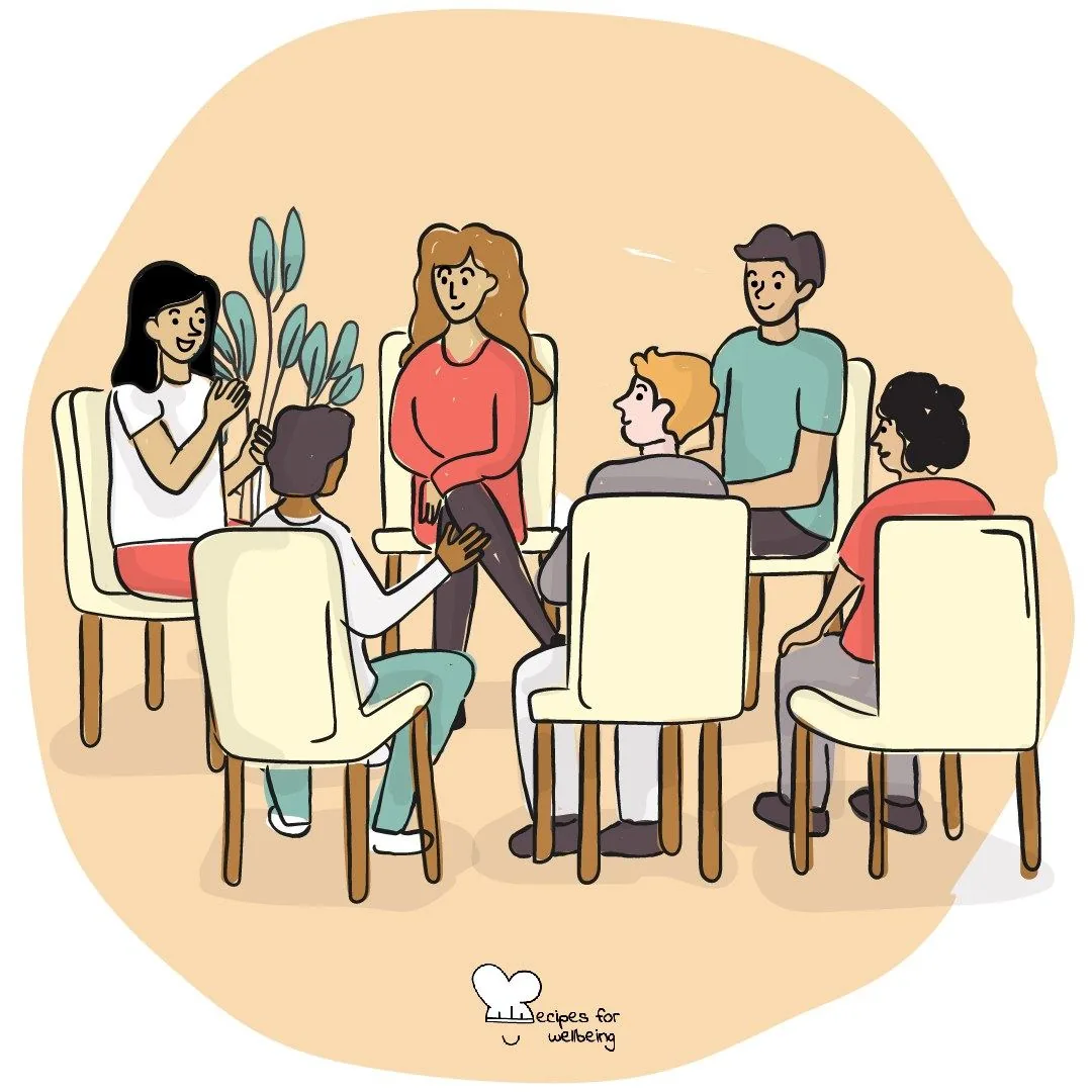 A circle of people sitting on chairs, turned towards one another