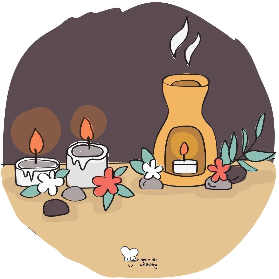 Lit candles, an oil burner and flowers arranged together