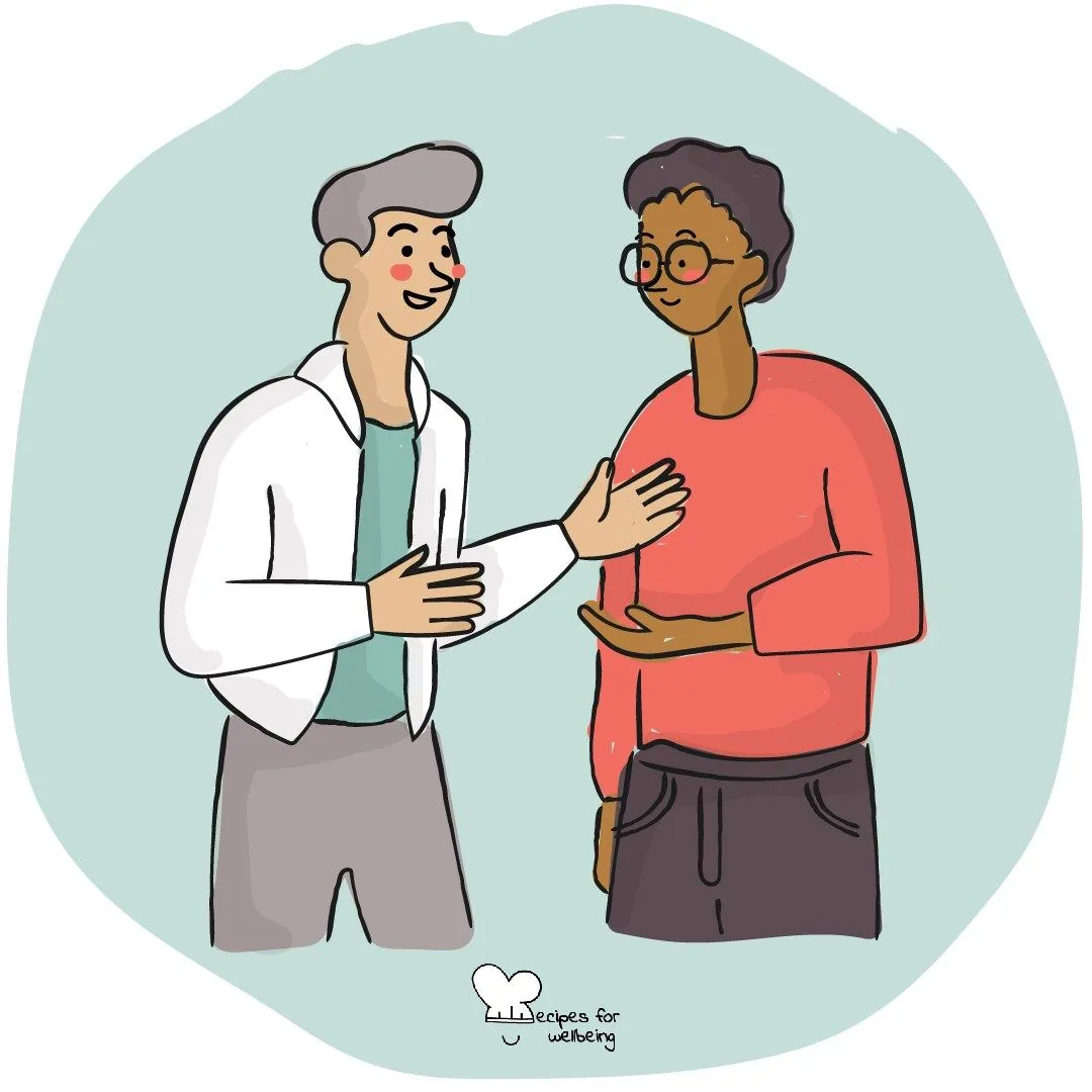 Two people standing and talking warmly