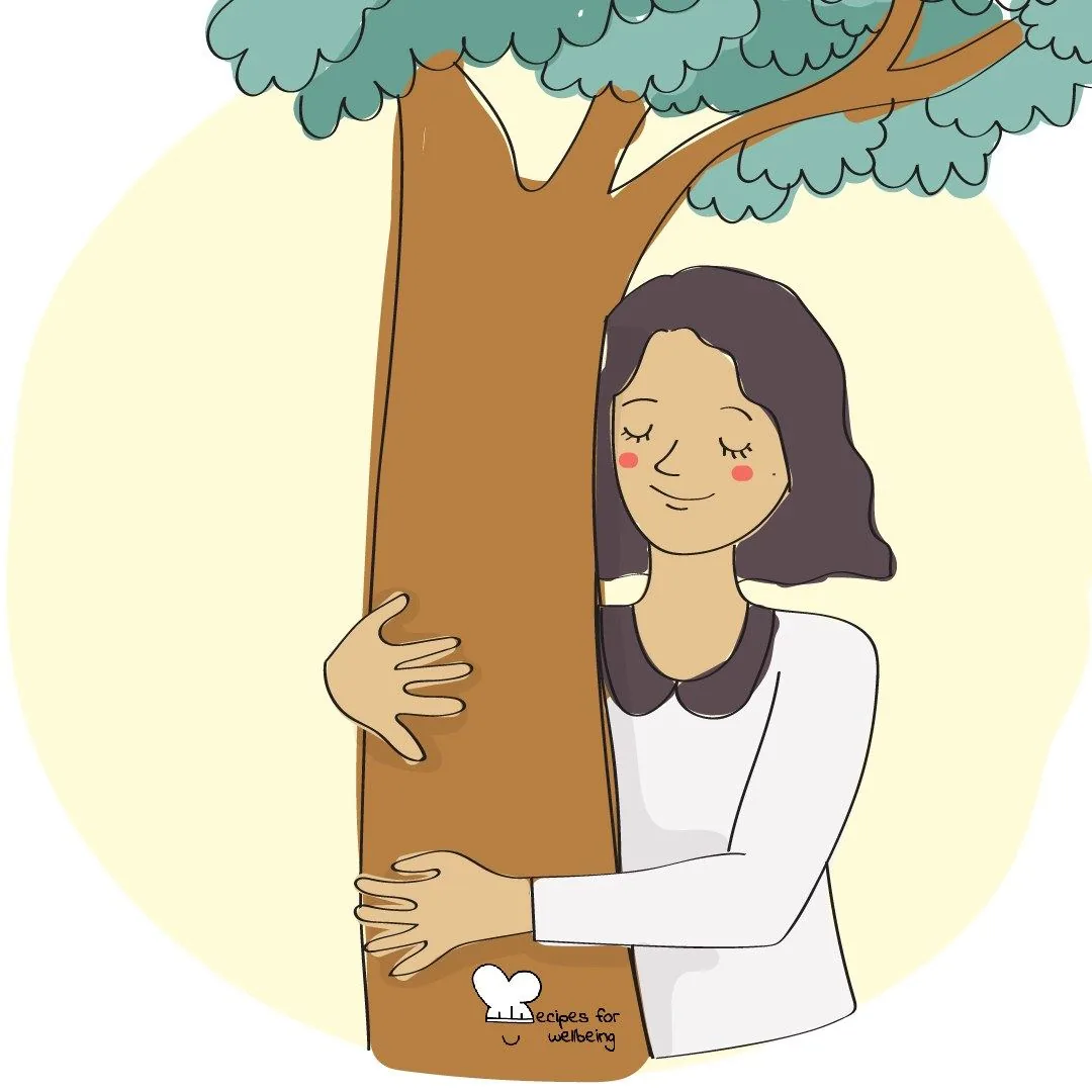 A person with their eyes closed, holding onto the trunk of a tree